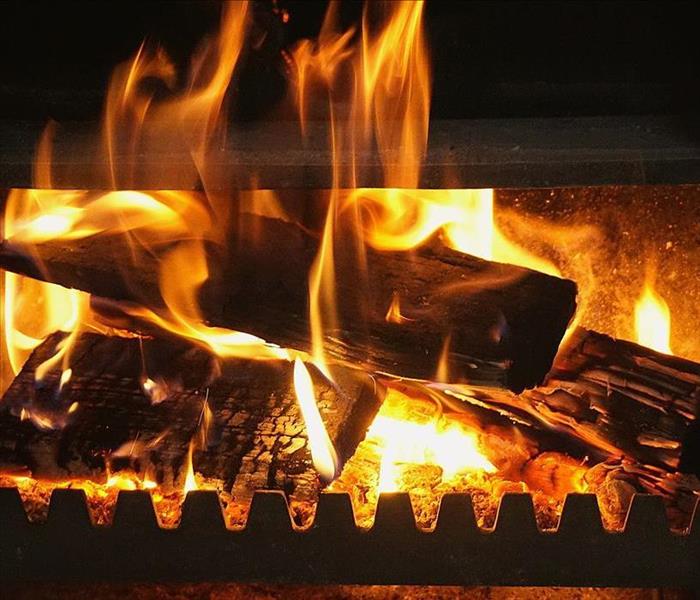 Wood burning in a fireplace.