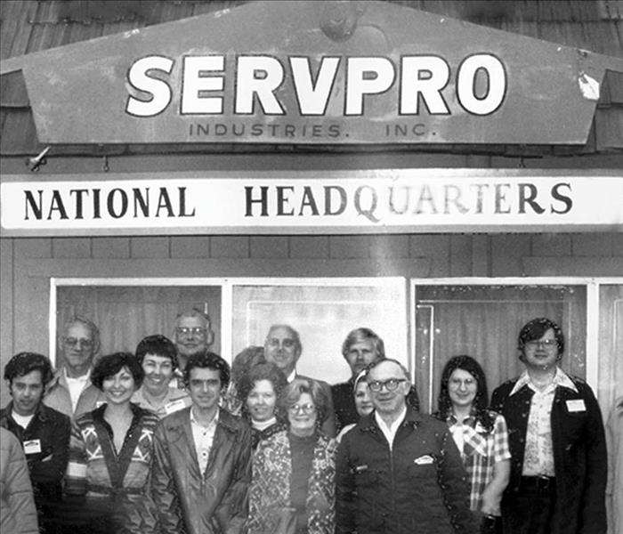 A family picture in front of the original SERVPRO Headquaters
