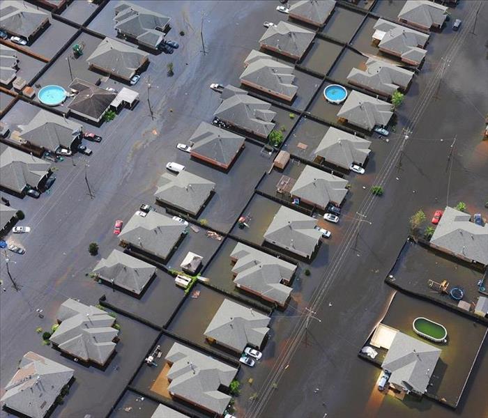 Overhead view of the tops of houses in a flooded neighborhood